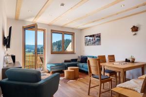 a living room with a couch and a table at Gantershof in Titisee-Neustadt