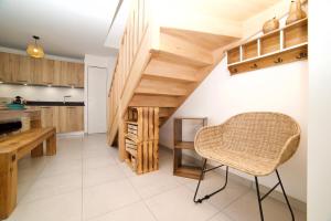 a kitchen with wooden stairs and a chair in a room at Le Bohème Facilité pour Genève et Annecy in Neydens +22 photos