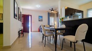 a dining room and kitchen with a table and chairs at Caribbean Tropical Villa - Free Electricity Included in Punta Cana +70 photos
