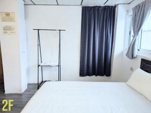 A bed or beds in a room at A-Lang Homestay