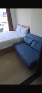 a bed and a couch in a room at La Casita Condo Hua Hin 6 in Hua Hin +1 photo