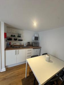 a kitchen with a table and a counter top at Valletta House Holiday Apartments in Skegness