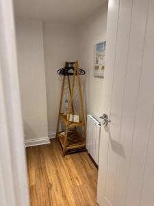 a hallway with a room with a wooden floor at Valletta House Holiday Apartments in Skegness