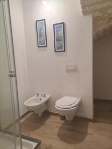 a bathroom with a toilet and a sink at Domo BM in Ossi