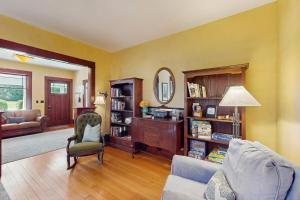 a living room with a couch and a chair at Sunny Hill Farmhouse in Fort Ward