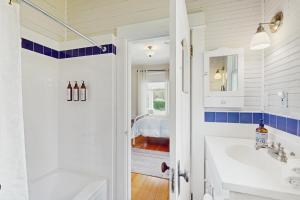 a white bathroom with a sink and a bed at Sunny Hill Farmhouse in Fort Ward +20 photos