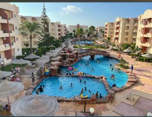 a group of people in a pool at a resort at Marseilia Resort in Al Ḩammām