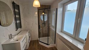 a bathroom with a shower and a sink at Apartament przy Sosnowej in Lublin +3 photos
