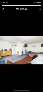 two pictures of a room with a bed and a living hype at Sunnyside guest house in Latchingdon and Snoreham