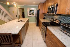a kitchen with a sink and a stove top oven at Beach Club Villa 39 by Wild Dunes, Oceanfront in Isle of Palms +34 photos