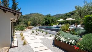 a garden with a swimming pool and a resort at Villa Charme 6 by Massimo Villas in SantʼAmbrogio
