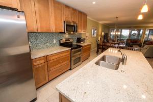 a kitchen with a stainless steel refrigerator and a sink at Beach Club Villa 39 by Wild Dunes, Oceanfront in Isle of Palms