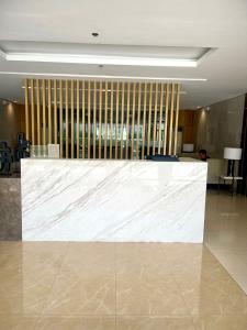 a large white marble counter in a lobby at Empirestatecation at Leaf Residences in Manila +14 photos