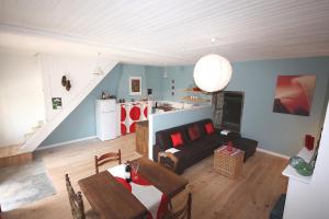 a living room with a couch and a kitchen at Beautiful country cottage in Limousin Natural Park in Bussière-Galant