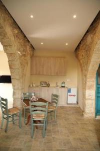 a kitchen with a table and chairs in a room at The Inn in Jbeil