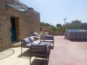 a group of chairs and tables on a patio at The Inn in Jbeil