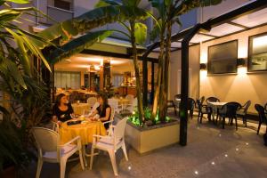 two women sitting at a table in a restaurant at Hotel Cavalluccio Marino in Gabicce Mare