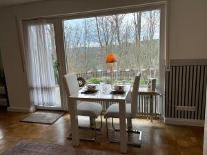 a dining room with a table and chairs and a large window at 1 Bedroom Terrace Appartment Near Pforzheim in Pforzheim
