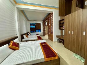 a bedroom with three beds in a room at homestay Việt Cường in Ta Pinh