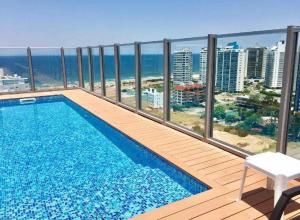 a swimming pool on the balcony of a building at Chronos in Punta del Este