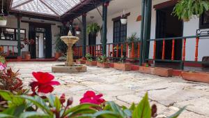 a courtyard with a fountain in front of a building at la posada del angel in Zipaquirá
