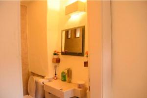a bathroom with a toilet and a sink and a mirror at Dana Sunset Village Hotel in Dana