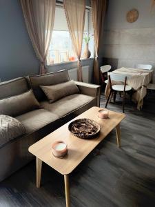 a living room with a couch and a table at Apartament Lux Nowe Ogrody 2 Poznań 24 H Lotnisko Airport in Poznań