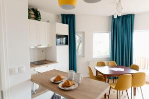 a kitchen and dining room with a table and chairs at Csillagvirág Apartman in Kismaros