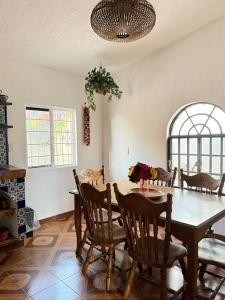 a dining room with a wooden table and chairs at Casa con Alberca La Mexicana in La Calera
