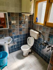 a bathroom with a toilet and a sink at Reshi guest house in Srinagar +5 photos