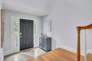a hallway with a black door and a table at Commons Court 3 by Wild Dunes, Golf Course View in Isle of Palms