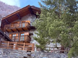 a log cabin with wooden balconies on a building at CASA VACANZE NORA in Chamois