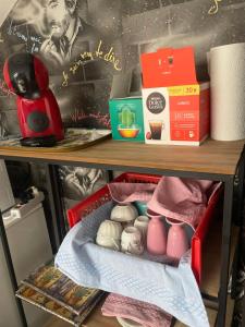 a drawer with a baby doll and other items on a shelf at Gainsbourg in Ouroux-sur-Saône