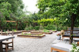 a garden with benches and raised beds at Emtec Farm Accommodation in Magaliesburg