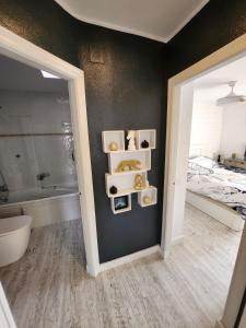a bathroom with a tub and a bed and a mirror at Casa in Spain in Sant Jordi