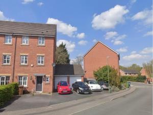 a brick house with cars parked in a parking lot at 5 Bedrooms, Sleeps 10, Free Parking, Near NEC & Airport, Contractors in Solihull