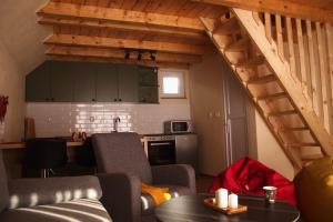 a kitchen and a living room with a loft at Evergreen Tiny Homes in Peje