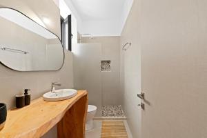 a bathroom with a sink and a mirror at Orianthia Stone Houses in Marantochori