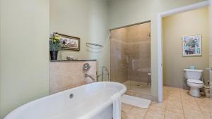 a bathroom with a tub and a shower and a toilet at Crescent Siesta Key Charmer in Siesta Key