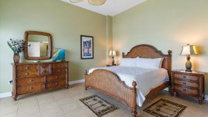 a bedroom with a bed and a mirror and a dresser at Crescent Siesta Key Charmer in Siesta Key