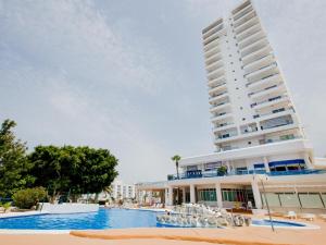 ein Hotel mit einem Swimmingpool vor einem Gebäude in der Unterkunft 309 Paraiso Sur luxury Studio in Playa Paraiso