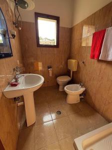 a bathroom with a sink and a toilet at Dario's Apartaments 2 in Orikum