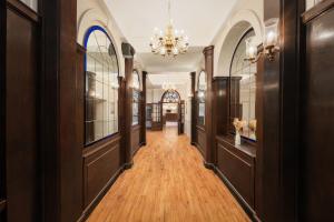 a hallway with wood floors and a chandelier at The County Hotel in Carlisle
