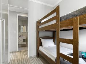 a bedroom with two bunk beds and a kitchen at Plaza Shopping Barbecue Court 3 bedrooms in Carapicuíba