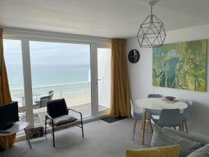 a living room with a view of the ocean at 26 Piazza - stunning seaviews of Porthmeor beach in St Ives