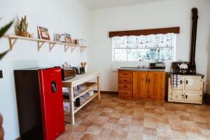 a kitchen with a red refrigerator and a counter at Die Koffie Huis in Sutherland