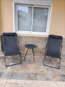 two chairs and a table in front of a window at Fabulous house near the beach in Calafell