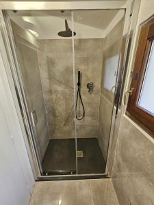 a shower with a glass door in a bathroom at Annade' guest house in Porto Rotondo