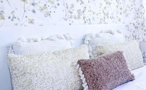 two pillows sitting on a bed in a room at El apartartamento de Santa Eva by Just Room in Miengo +22 photos