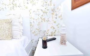 a bedroom with a bed and a table with a remote control at El apartartamento de Santa Eva by Just Room in Miengo